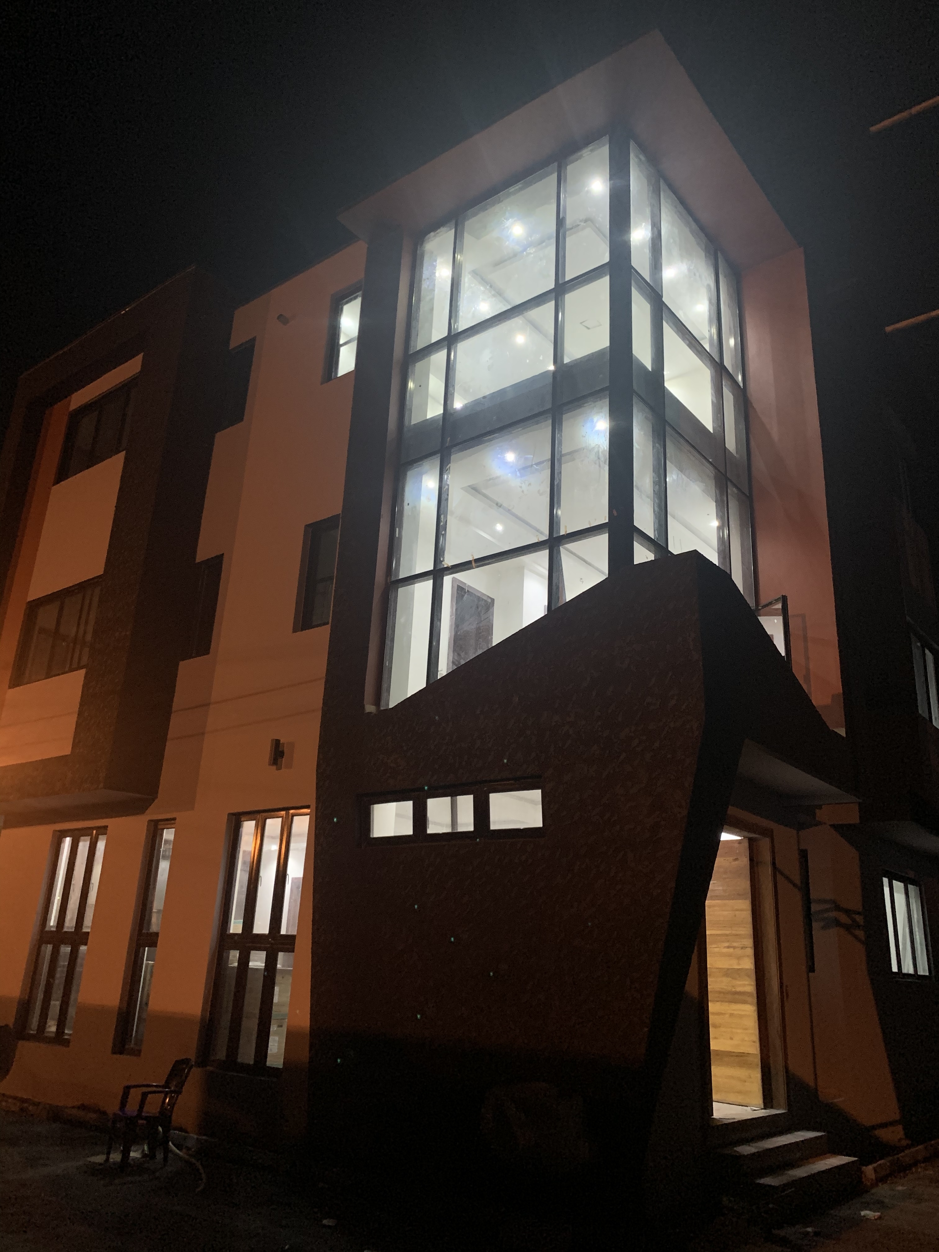 Architectural facade and double-height glazing at Andrews Creek in Ikoyi, Lagos
